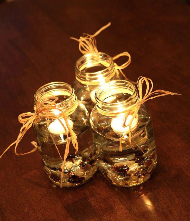 Mason jar decorated with stones and lights for eccentric wedding centrepiece