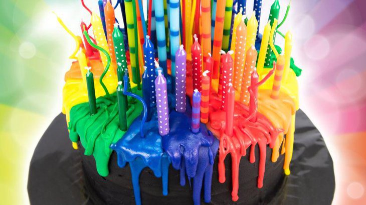 Melting candle rainbow themed birthday cake