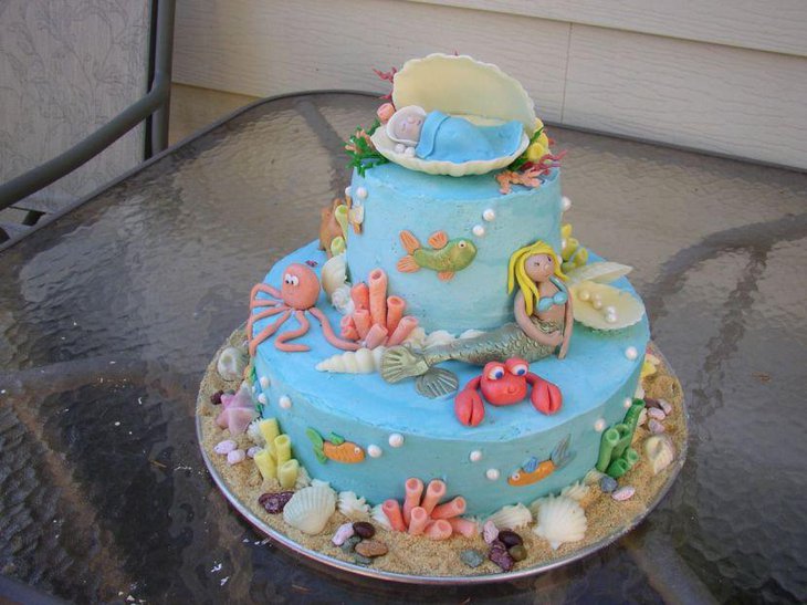 Mermaid baby shower themed cake decor with seashells and sleeping baby