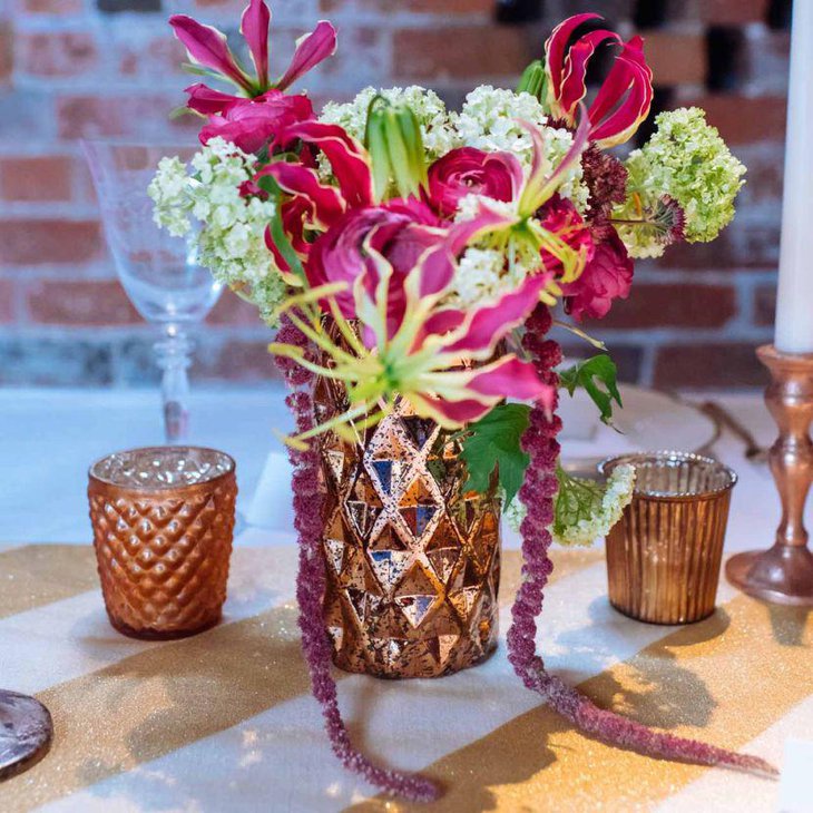 Metallic copper vase floral centerpiece on spring table