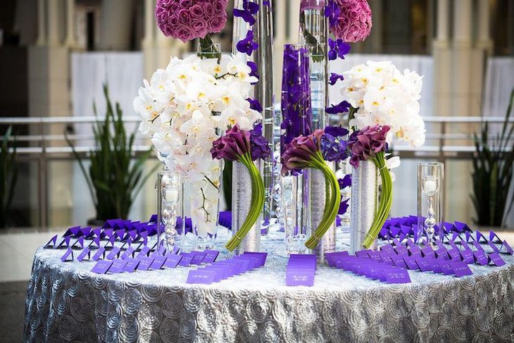 Modern purple themed wedding reception escort card table