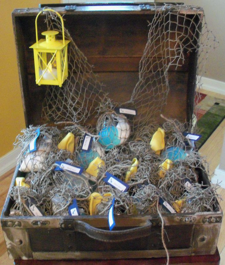 Nautical baby shower table decor with treaure chest lantern and net