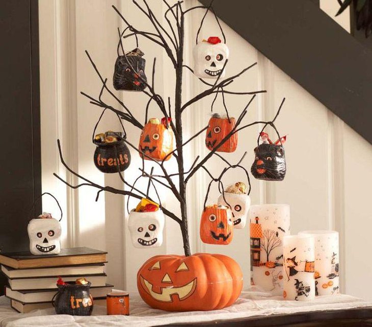 Outstanding DIY branch with hanging scary pots as Halloween table centerpiece