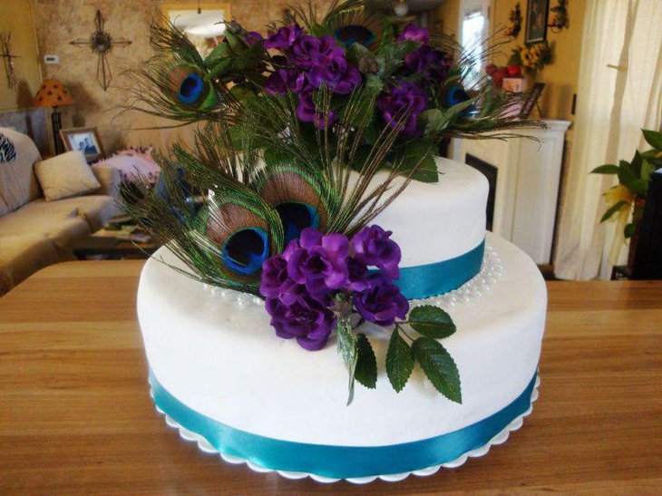 Peacock feathers and purple floral centerpiece