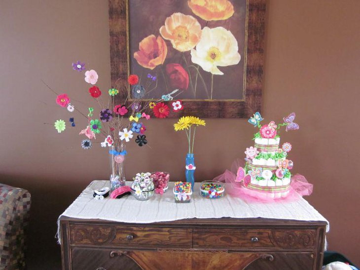 Pink and purple butterfly diaper centerpiece on baby shower table