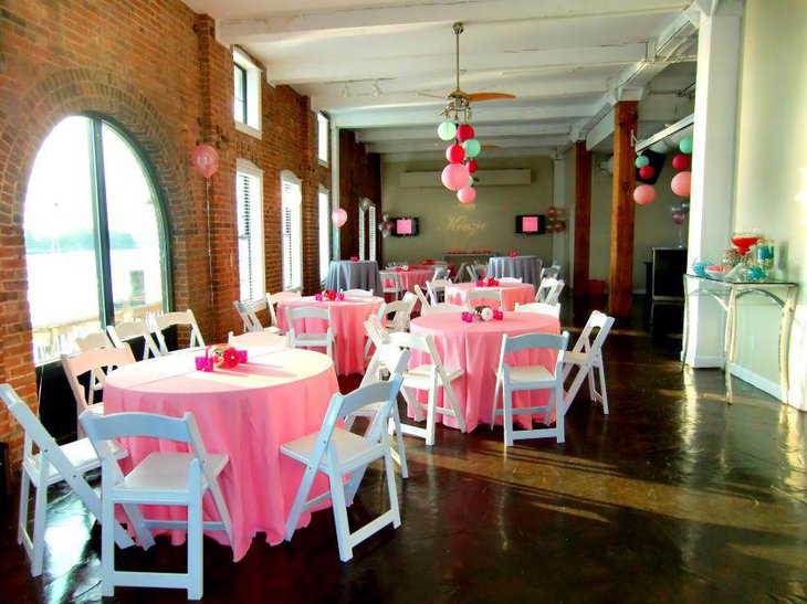 Pink decorations look cute on these sweet 16 birthday tables