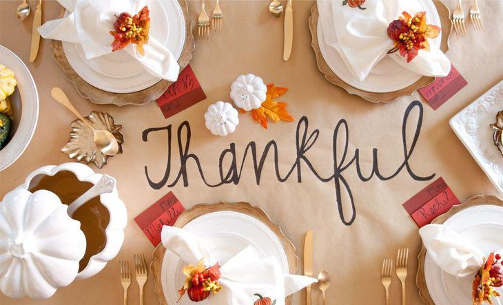 Plain brown paper Thanksgiving table runner with Thankyou message written on it