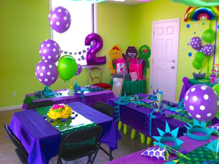 Purple balloon decorations on party table
