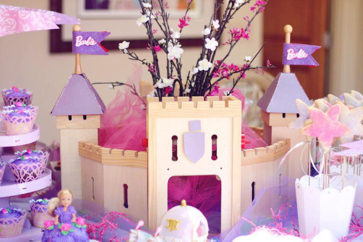 Purple Barbie themed castle decor on birthday party table