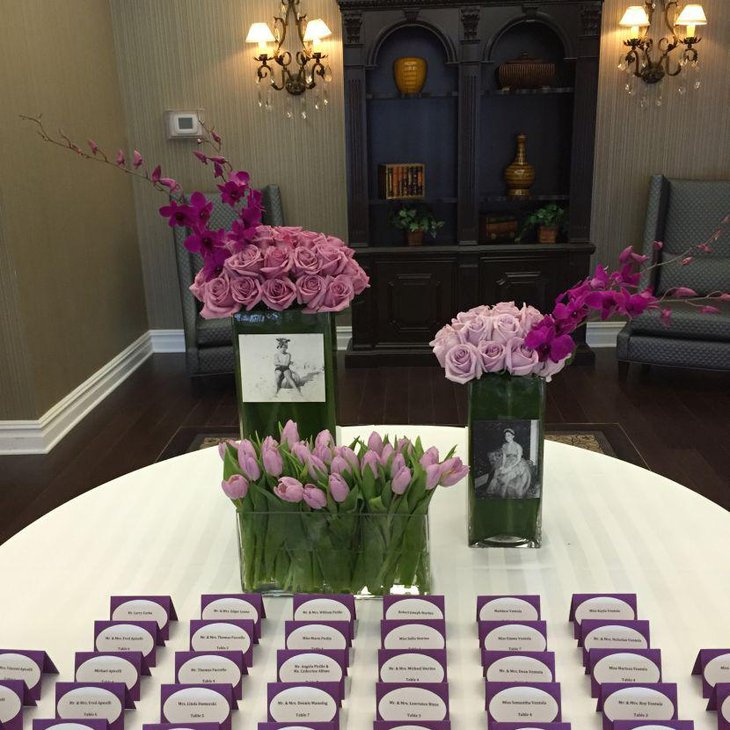 Purple floral centerpiece on 80th birthday table
