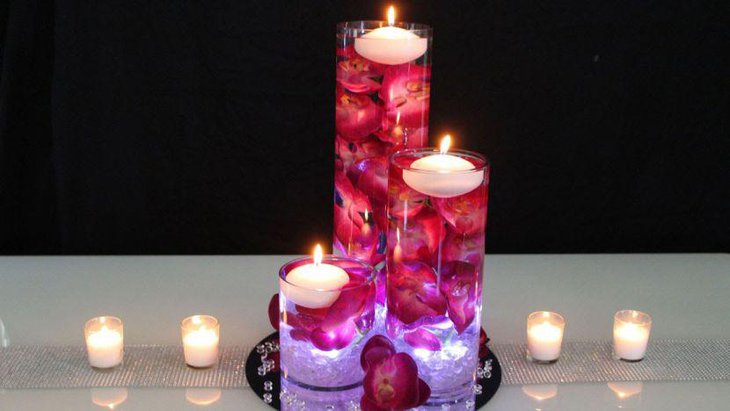 Red and white accented floating candle wedding table centerpiece