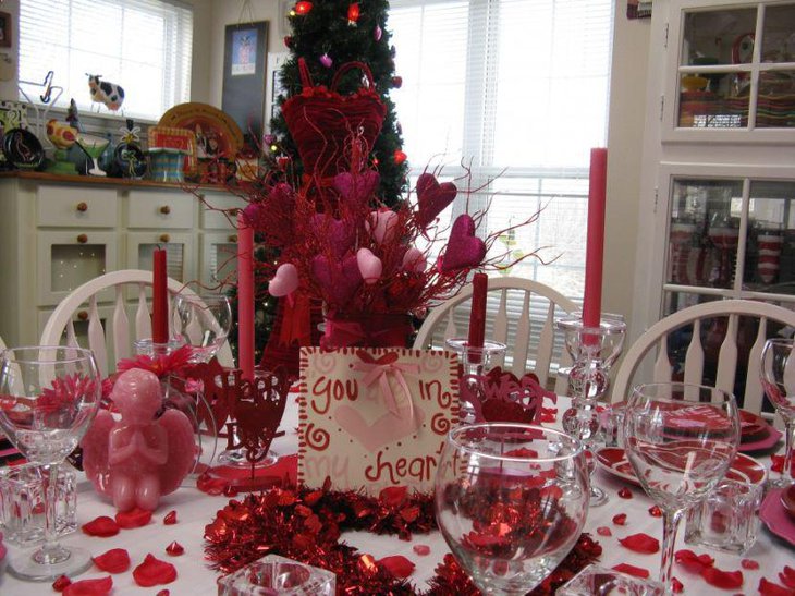 Red angel figurine and candles on Christmas table