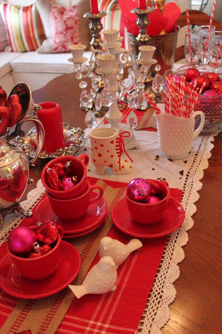 Red cups filled with shimmering balls on Valentines table