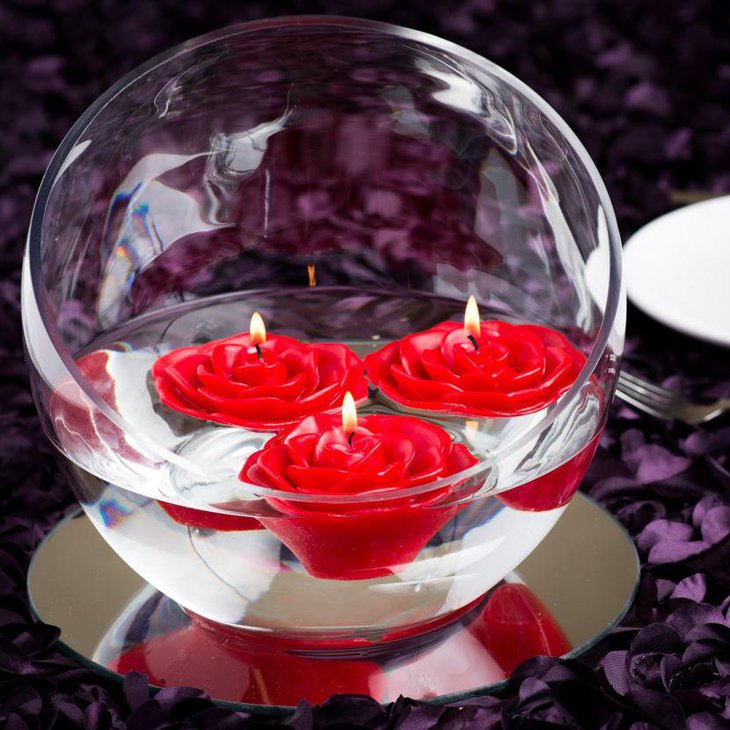 Red rose floating candles centerpiece on Valentines table