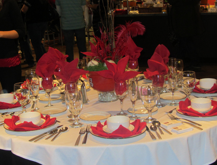 Round Wedding Tables Donned In Bright Colors and a red centerpiece