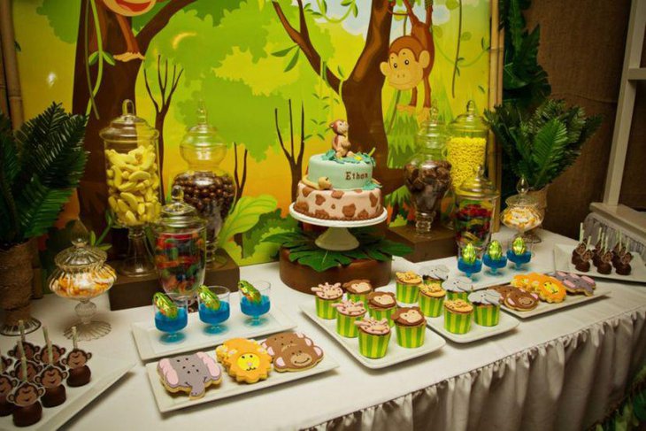 Safari theme dessert table with lots of greens and animal shaped yummy desserts