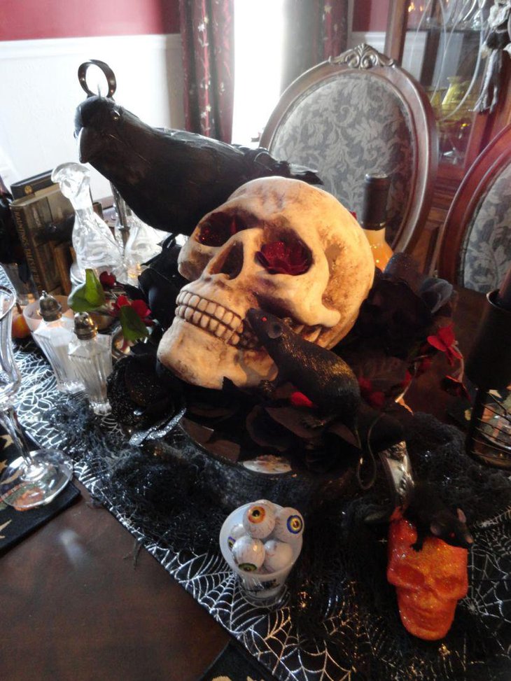 Scary skull Halloween table centerpiece with crows and rats
