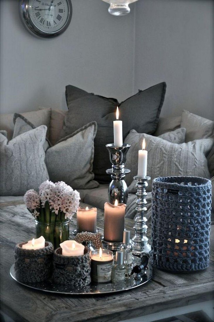 Silver accented candlesticks and tray decoration on coffee table