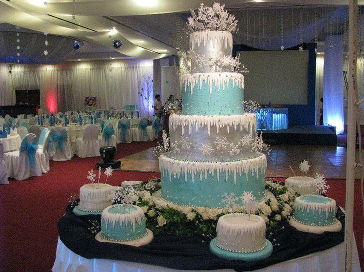 Stunning blue and silver cake decoration with snowflakes on winter table