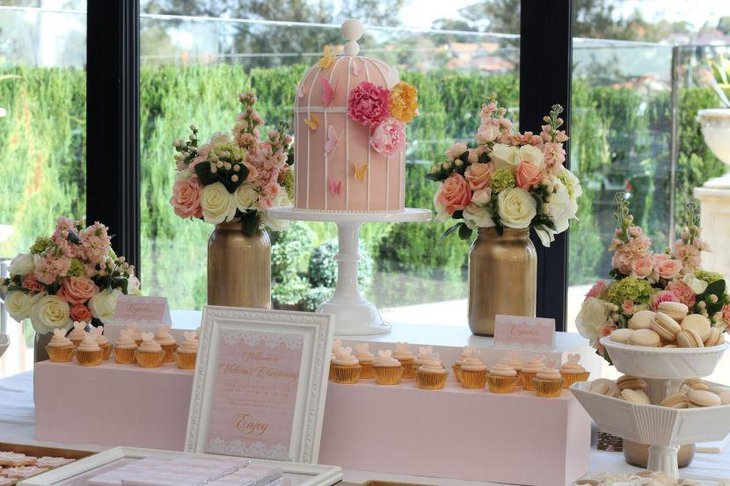 Stunning cake table decor with metal vases filled with flowers