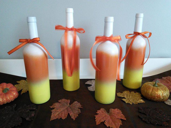 Stunning candy cane wine bottles with ribbons as Halloween table centerpiece