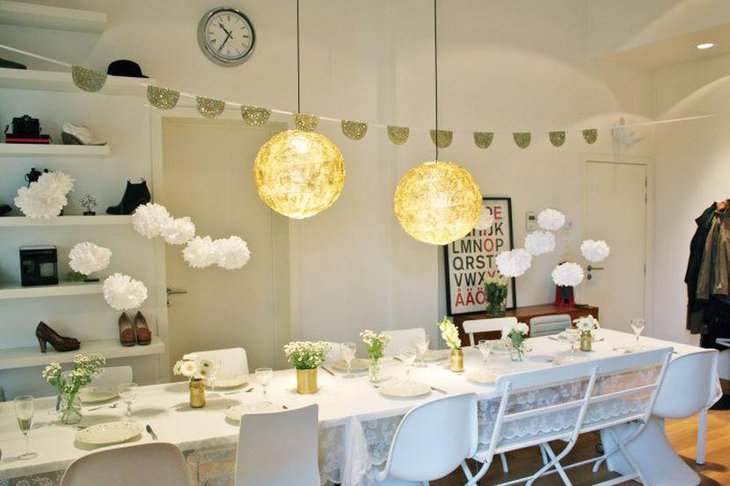 Stunning DIY party table setting with golden metal cans glass jars and fresh flowers