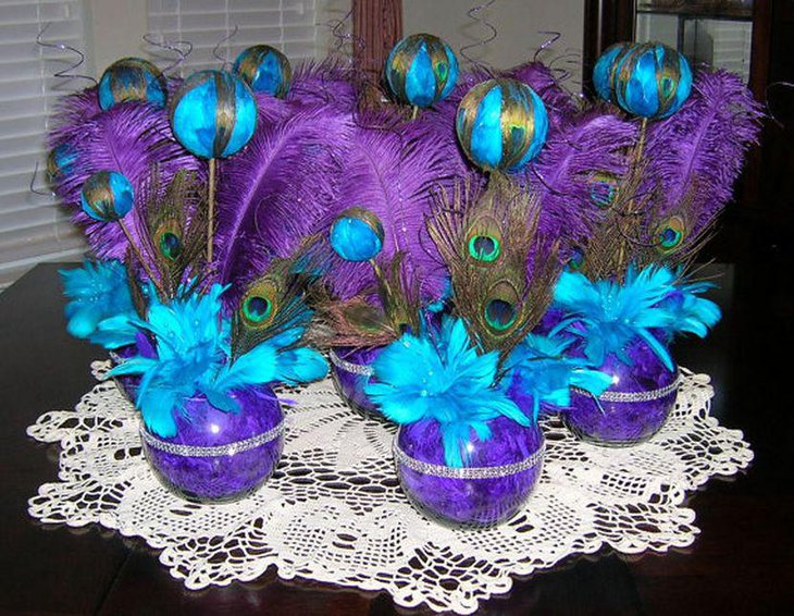 Stunning purple peacock themed wedding table centerpiece with teal accents