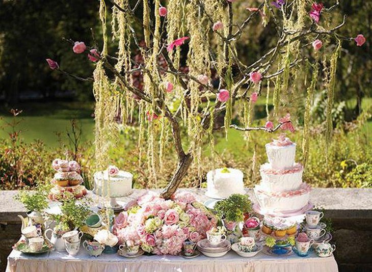 Stunning spring garden party table decor with floral arrangement and branch centerpiece
