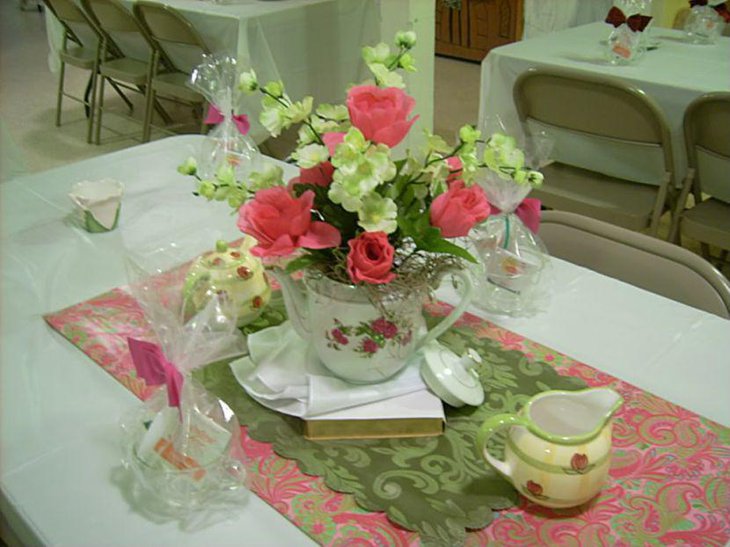 Stunning tea party table decor with ceramic vase filled with flowers
