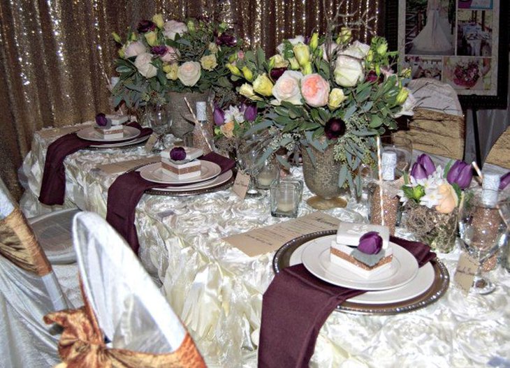 Stunning wedding table decor with purple napkins and flower buds