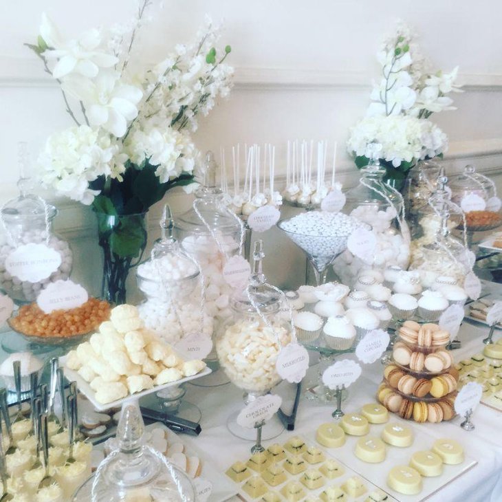 Stunning white candy table with floral decor
