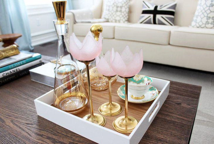 Stylish golden decanter and glasses decor on coffee table