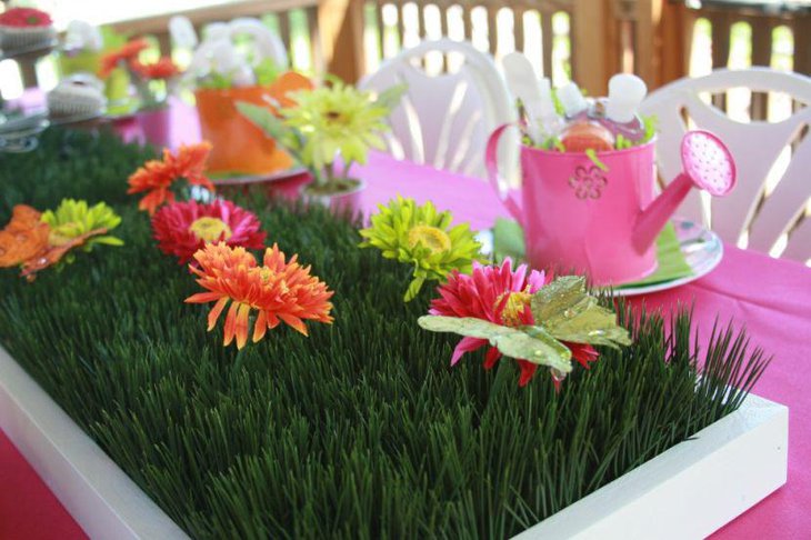 Summer garden party table decor with fresh flowers and grass centerpiece