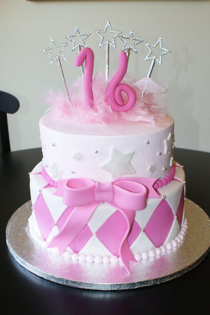 Sweet 16 birthday cake with silver wands and pink bow