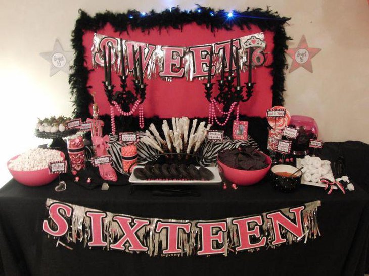 Sweet 16 birthday table decked with black candles in candelabras