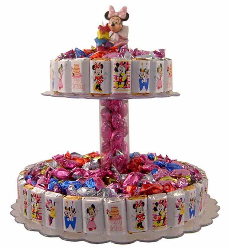 Sweet Minnie Mouse candy bar cake centerpiece idea on candy table