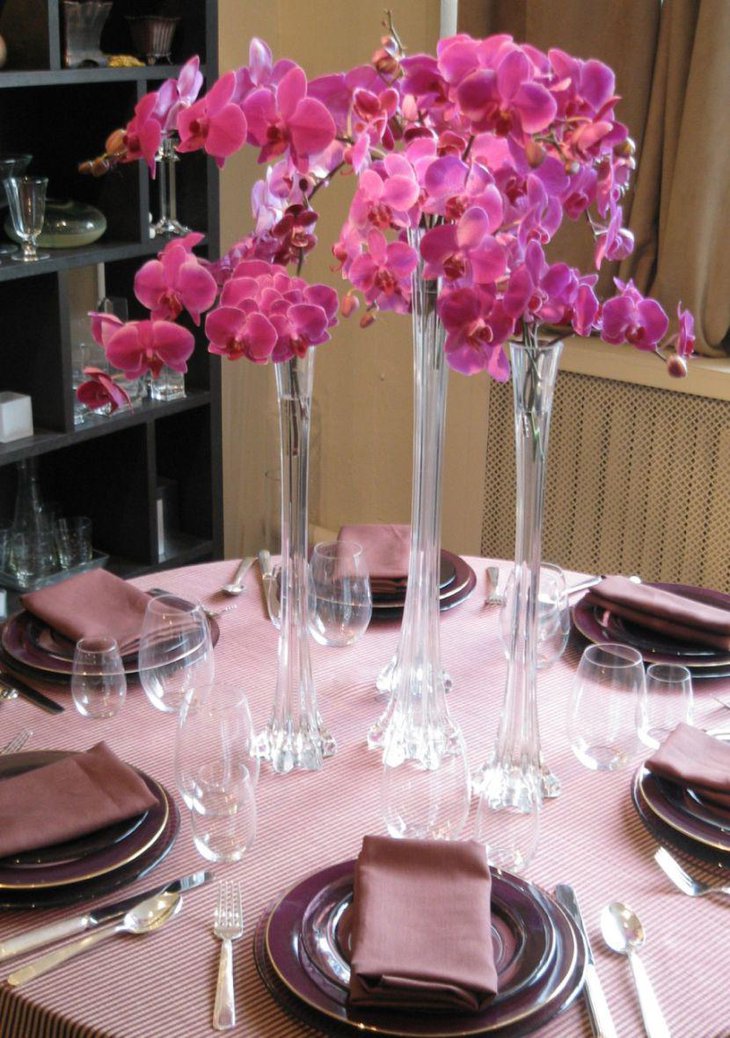 Tall glass vase centerpieces on spring table