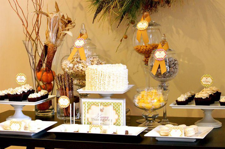 Thanksgiving dessert table decor with couture cake and vases filled with dry corncobs and pumpkins