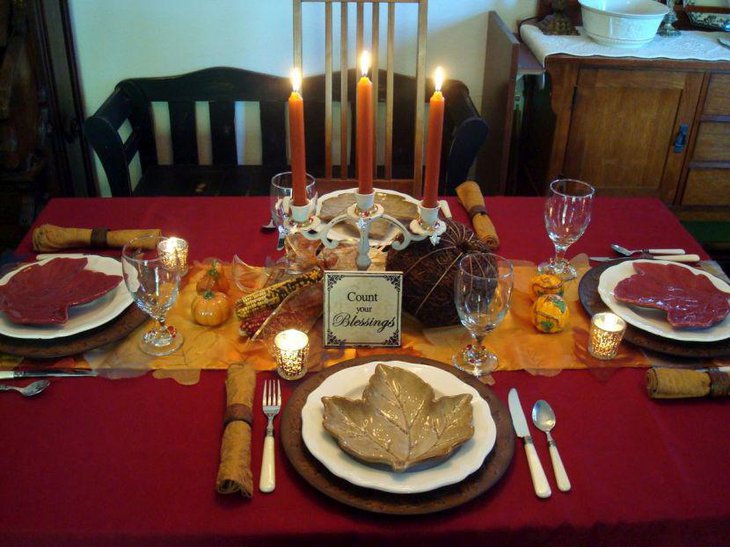 Thanksgiving table decor with Orange candles and white holder