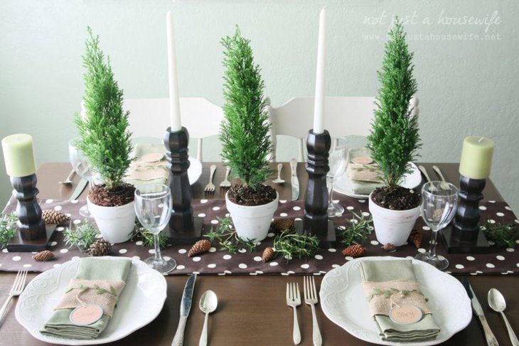 This chocolaty Christmas table looks warm with candles and planters