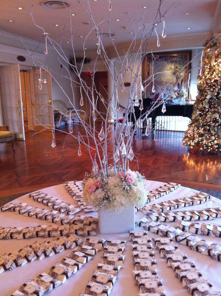 This winter wonderland table looks gorgeous with a twig centerpiece decked up with hanging crystals