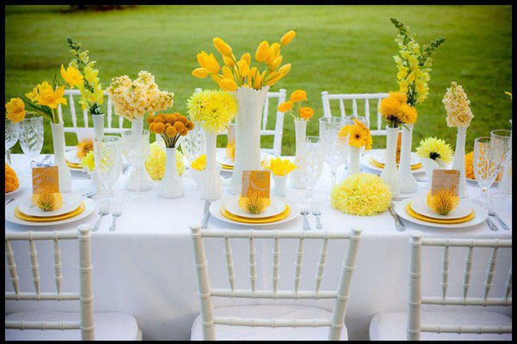 Vibrant garden party table decor with yellow flowers