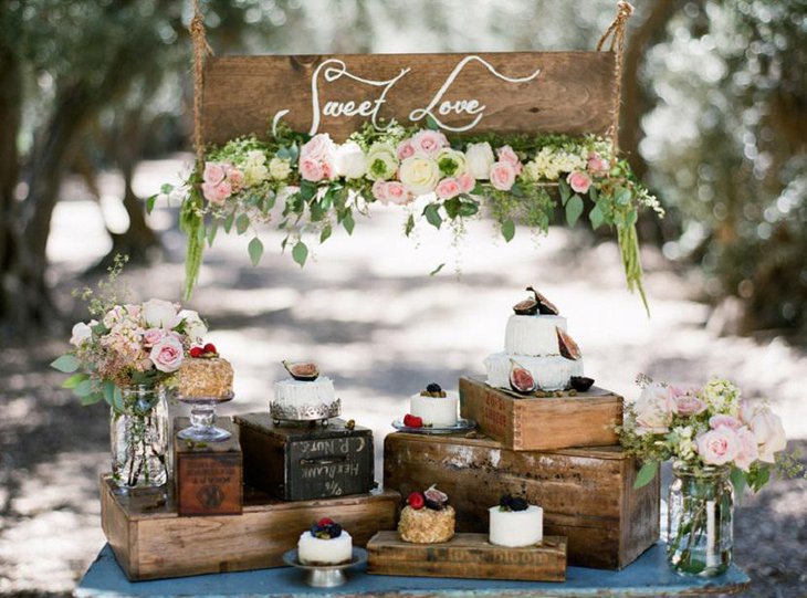 Vintage Outdoor Wedding Dessert Table with Barrels and Lights
