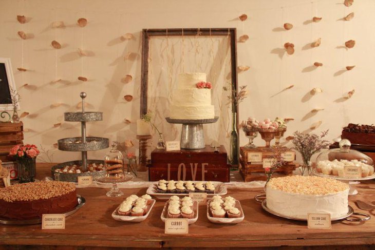 Vintage wedding dessert table decor with white cake and pastel accents