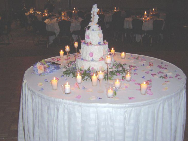 Wedding cake table in white with candle decor