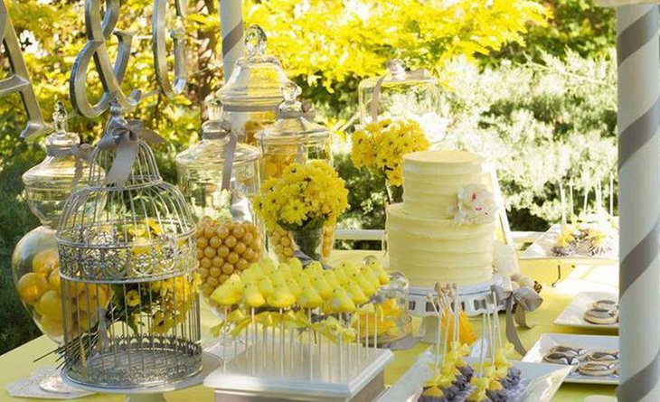 Wedding dessert table decor with bright yellow flowers