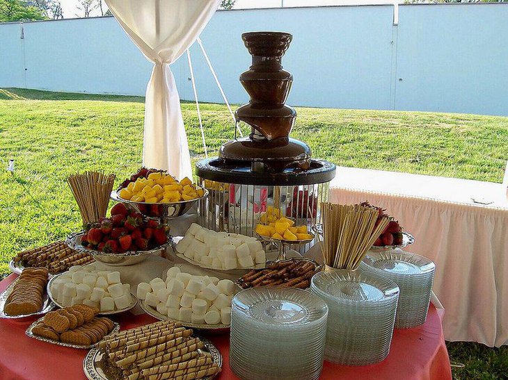 Wedding dessert table decor with chocolate fondue station and savories