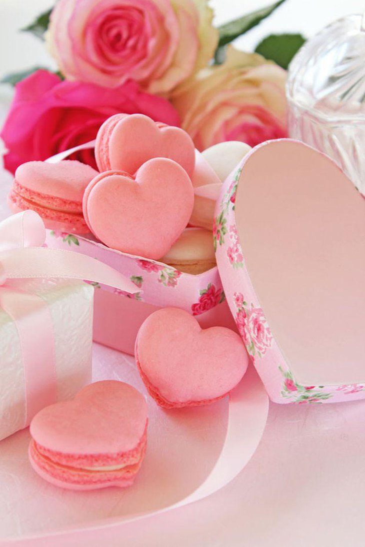 Wedding dessert table decorations with pink heart shaped cookies in a box