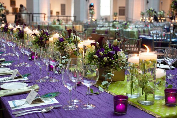 Wedding table decor with low floral centerpieces in purple tones