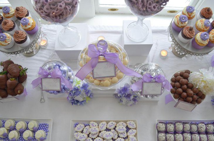 White and purple candy display on baby shower candy table